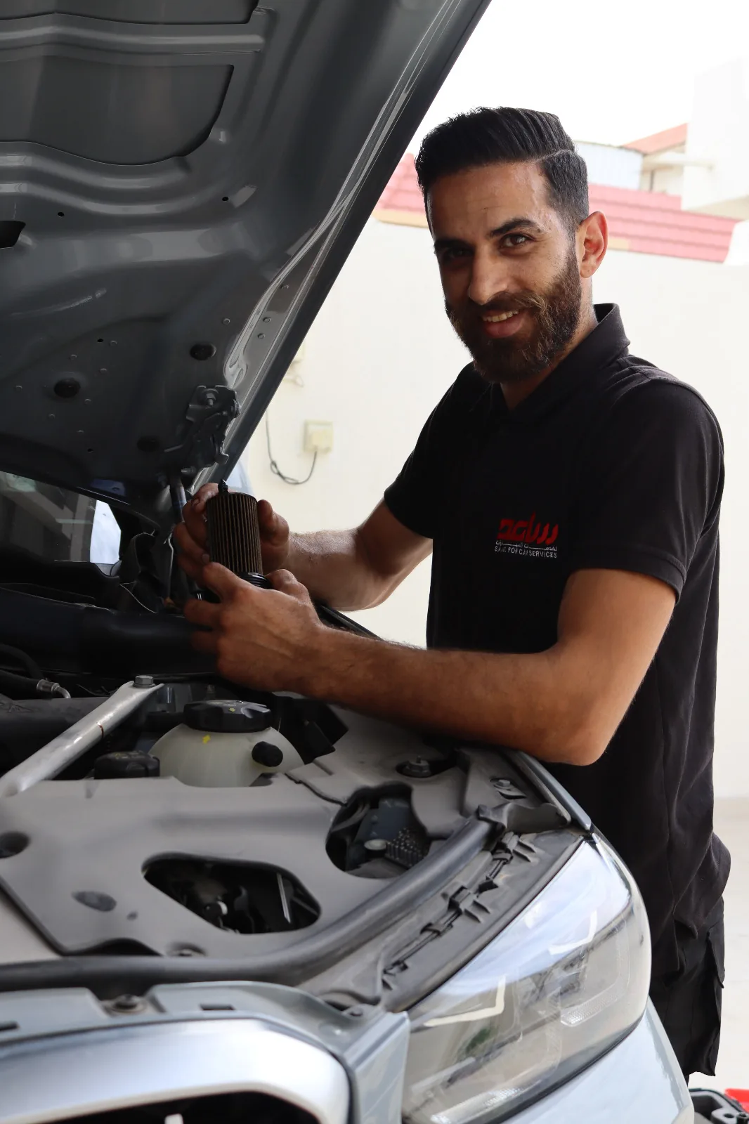 Mobile mechanic working on a car